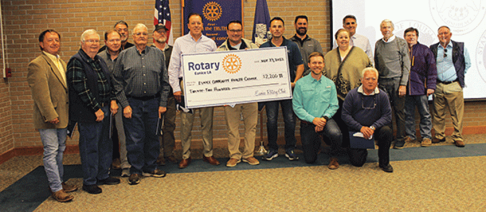 The Eunice Rotary Club presented a $2,200 check to Glyn Michaud, pharmacist at the Eunice Community Health Center, to help defer the cost of the replacement of the front glass doors of the center that were vandalized. From left, are Donnie Richard, John Fontenot, Jerome Fontenot, David Clause, Bob Soileau, David Reed, Kip Bertrand, Michaud, Coby Clavier, Jacob Bergeron, the Rev. Andrew Bates, Shirley Vige, Pat Dossman, John Hamlin, Don Mayeux, Ellis Daigle and Randall Vigee. (Photo by Myra Miller)