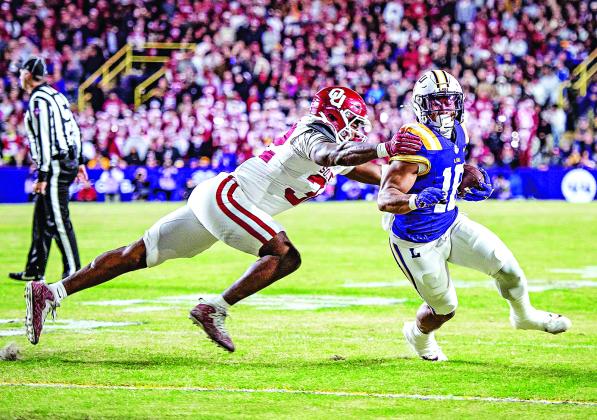 LSU’s Josh Williams tries to escape an Oklahoma defender. (Photo by Dwight Jodon)
