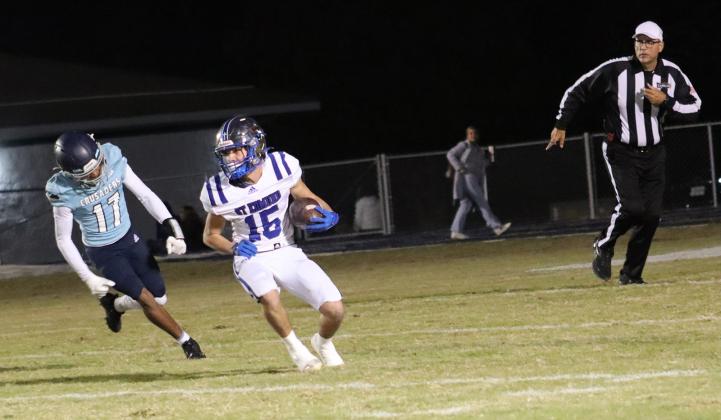 St. Edmund Blue Jay Hudson Simon, a junior and a wide receiver and cornerback runs with the ball and looks for yardage. (Photo by Amy Myers)