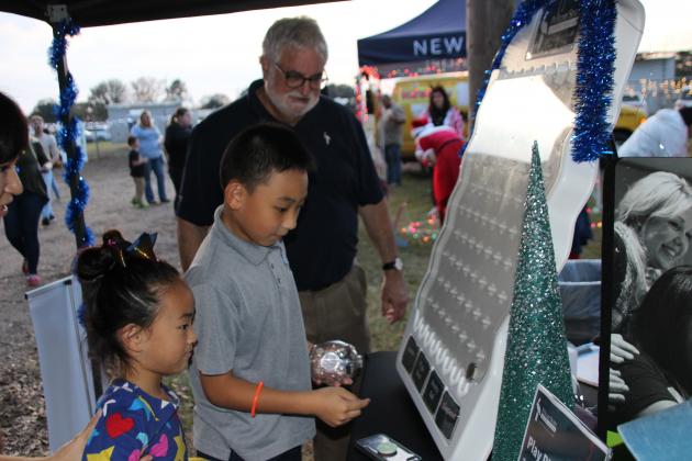 A Plinko game at Pelican State Credit Union's booth