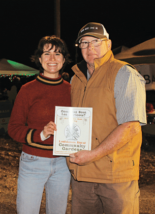 Jane Ainsley Rothschild, an Extension Support Specialist Seed to Supper Program Assistant Horticulture Section, from Cornell College of Agriculture and Life Sciences in Ithaca, New York, attended the Eunice Community Garden Christmas Festival. Rothschild wrote articles about community gardens in Louisiana. She is with Randy Miller, director of the Eunice Community Garden. (Photo by Myra Miller)