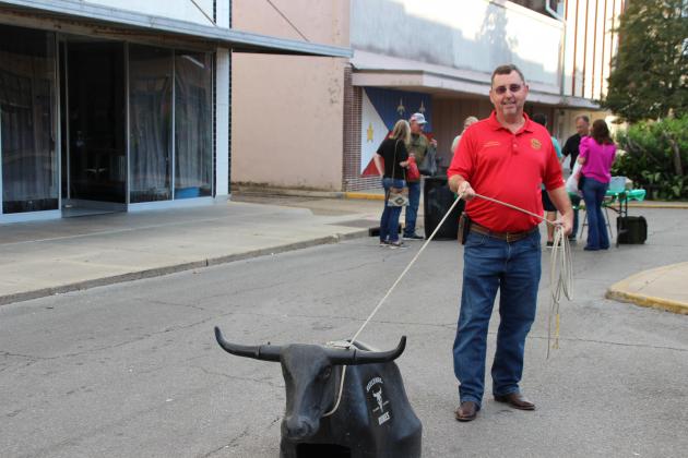Jessie Bellard having fun roping a bull at downtown Second Street