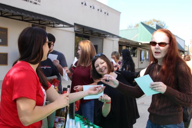 Greta Fontenot hands out samples of different wines