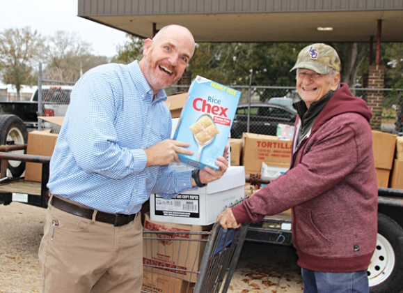 Rev. Brent Shoalmire and Allie Fontenot, were among the many volunteers at the annual Eunice Food Bank Food Drive held Tuesday. About 5.5 tons of food was collected. (Photo by Myra Miller)