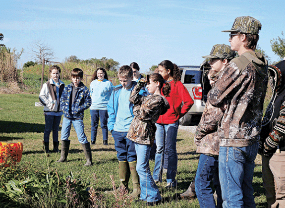 4-H’ers listen as organizers explain the history of Cajun prairies and how the students will go about planting the seeds at the Lacassine National Wildlife Refuge. (Photo by Anthony Bailey/AgCenter)