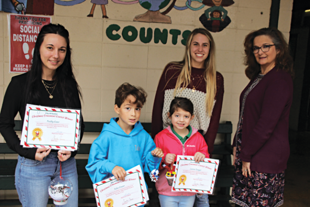 From left, are Heather Lanclos with the Mayor’s Office, Talan Ceasar, and Lauren Douget, Ornament Contest winners; Courtney Elkins with City of Eunice;  and Principal Laura Lombas. Not pictured is Paisley Cesar. (Photos by Myra Miller)