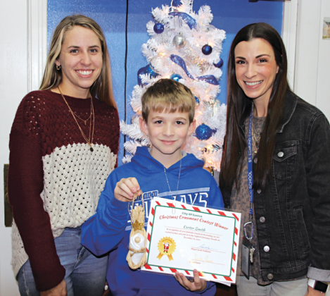 From left are Courtney Elkins with the Mayor’s Office, Carter Smith, a fifth grader at St. Edmund Elementary; and Maggie Fuselier, secretary at St. Edmund High. Smith was the winner at St. Edmund in the city’s Christmas Ornament Contest.