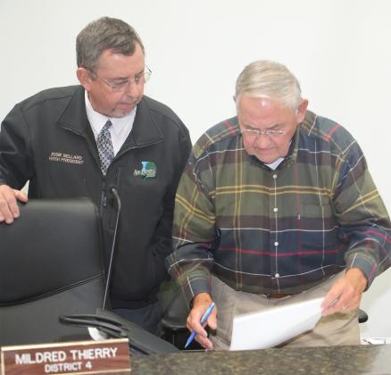 St. Landry Parish President Jessie Bellard, left, and Council member Harold Taylor meet before public hearing on Wednesday. (Photo by Harlan Kirgan)