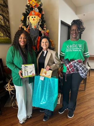 Eunice Manor Administrator Nickie Toups was greeted and welcomed donated items from Shelsy Williams, left, and Patricia Harrison of the NAUW Eunice Branch.