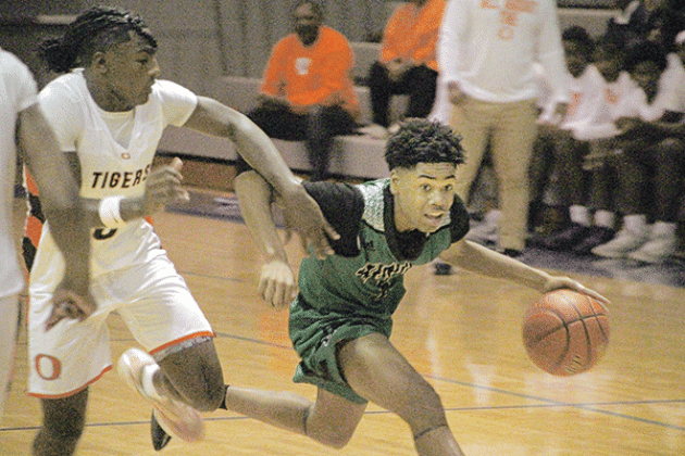 Eunice guard Devonte Johnson moves past an Opelousas defender in Wednesday’s loss at the parish tournament.