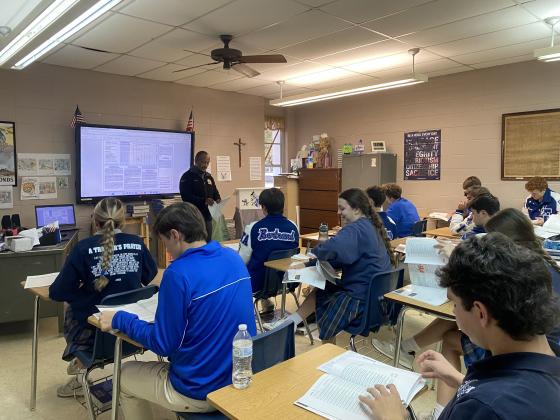 Stephen Wall, a Armed Services Vocational Aptitude Battery career exploration program test coordinator, assisted St. Edmund students with interpreting their vocational aptitude battery results.