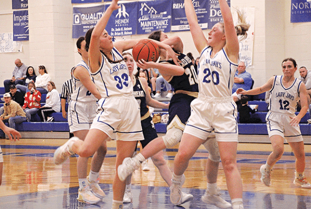 St. Ed’s Jillian Devillier and Ava Smith defend Sacred Heart’s Alyssa Brignac during a game of the Brad and Kendall Fontenot Memorial Shootout held at St. Ed’s last week. (Photos by Rhett Manual)