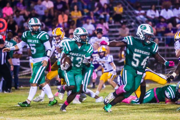 Thaddeus Godfrey (23) behind the block of Jalen Anderson (54)