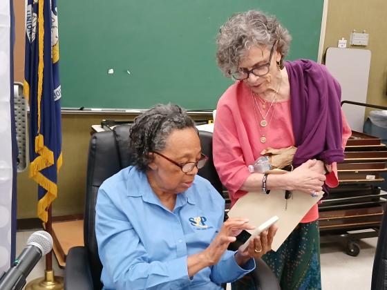 School board members Hazel Sias and Mary Ellen Donatto look over the budget before leaving a school board meeting. (Photo by Bobby Ardoin)