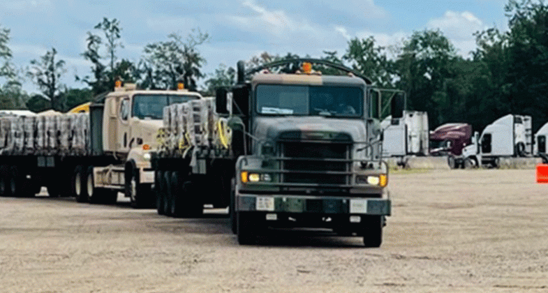 The Louisiana National Guard lines up trucks and trailers ready to deliver food and water to affected citizens following Hurricane Ida at the Regional Staging Area in Tangipahoa Parish, Louisiana, Aug. 28. 2021. In addition to 195 high-water vehicles and 73 rescue boats prepped and staged across south Louisiana, the LANG has 34 helicopters ready to support search and rescue, evacuation and recon missions as needed. (U.S. Army National Guard courtesy photo)
