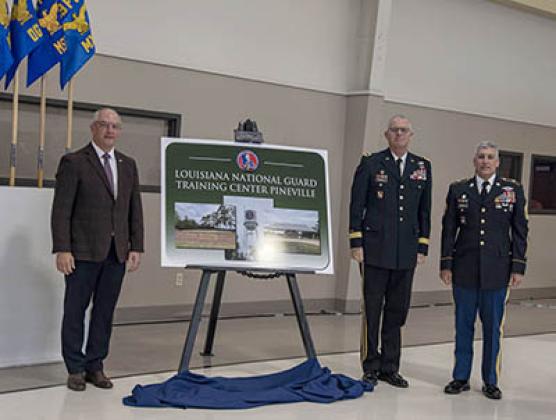 Louisiana Governor John Bel Edwards, Louisiana National Guard Adjutant General Maj. Gen. Keith Waddell and Louisiana National Guard Senior Enlisted Leader Command Sgt. Maj. Clifford Ockman unveil the Louisiana National Guard Training Center Pineville signifying the installation’s redesignation from Camp Beauregard to LANG TCP during a redesignation ceremony at the Dabadie Gym in Pineville, Louisiana, Oct. 18. (U.S. Army National Guard photo by Staff Sgt. Noshoba Davis)