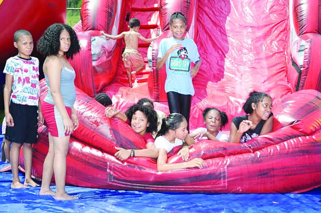 Children playing on bounce house slide