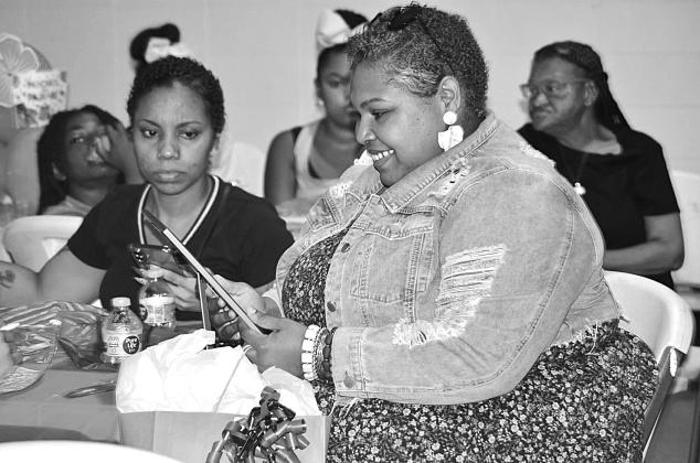 Woman smiling at Pancakes &amp; Pajamas event
