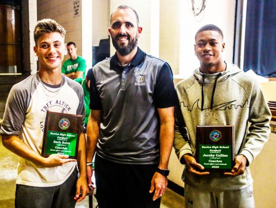 Coach Josh Guidry gives the Faize Mahfouz Memorial Award to  Myles Woods and Dylan Darbonne at the annual Bobcat football awards ceremony.