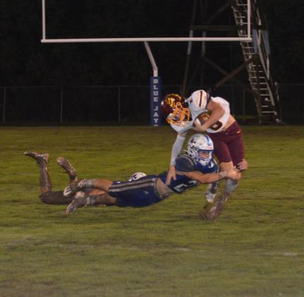 St. Ed's Jay Lavergne tackles an Iota ball carrier.