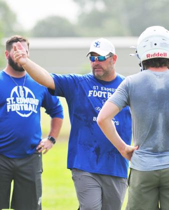 St. Ed's Nick Trosclair talks with a Blue Jay player