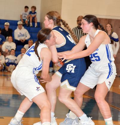 St Edmund’’s Caroline Lavergne and Millie Miller battle Sacred Heart’s Rose Ardoin for a jump ball.