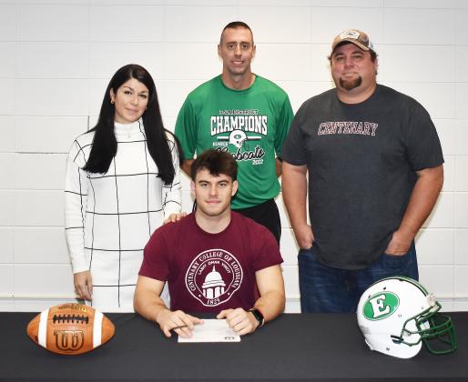 Eunice High’s Josh Brown, sitting, signed a national letter of intent to play football at Centenary College in Shreveport. Standing, from left, are his mother Kelly Arceneaux, Eunice head football coach Andre Vige and father Lance DeRouen.