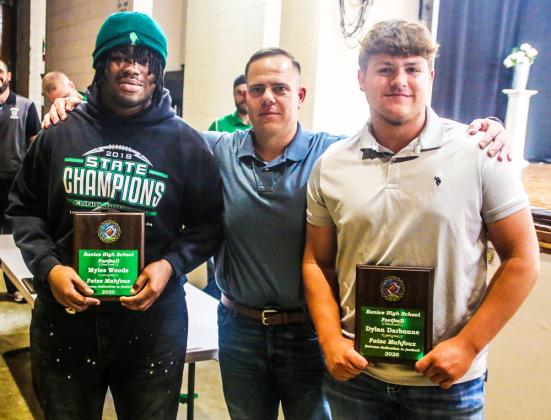 Coach Josh Guidry gives the Faize Mahfouz Memorial Award to  Myles Woods and Dylan Darbonne at the annual Bobcat football awards ceremony.