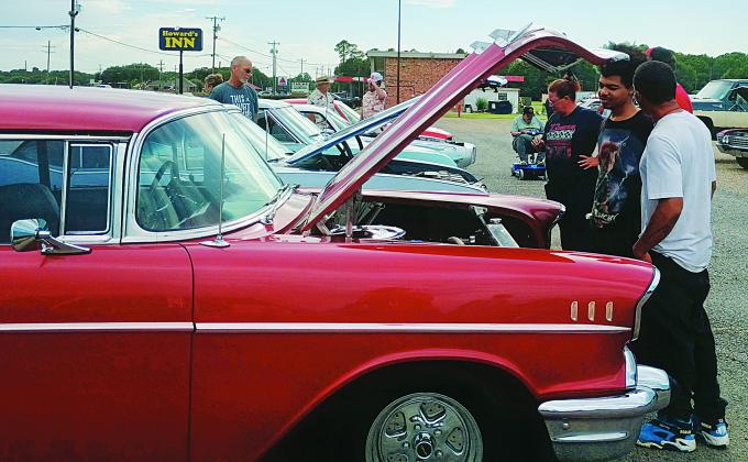 Car &amp; Truck Enthusiasts peering at engine