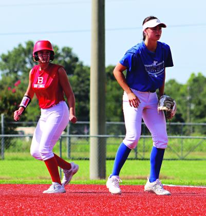 Ten teams from around Acadiana have been participating in Metro Ball being held at the Eunice Recreational Complex. At left, Basile’s Jensen Doucet attempts to leave first base as St Edmund’s Aubrie LeJeune plays first.