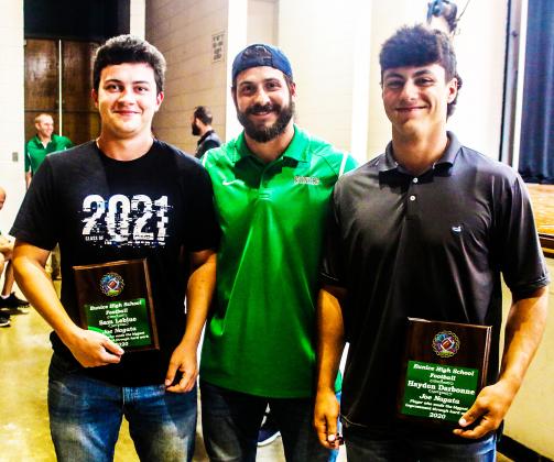 Eunice coach Trenon Trosclair gives the Joe Nagata Memorial Award to  Sam Leblue and Hayden Darbonne during the Bobcat football awards ceremony.