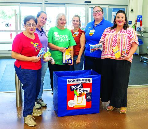 Posing in front of the Food Drive collection box at Walmart are, at left, Donna Baltakis, director of Keep Eunice Beautiful, sponsor of the drive; at third from left, KEB board member Fran Guillory; and, at right, Katie Richard, founder of Belly Buddies. They are pictured with Walmart associates Amanda Aymond, Rebecca Bordelon, and Courtney West. (Photo by David Simpson)