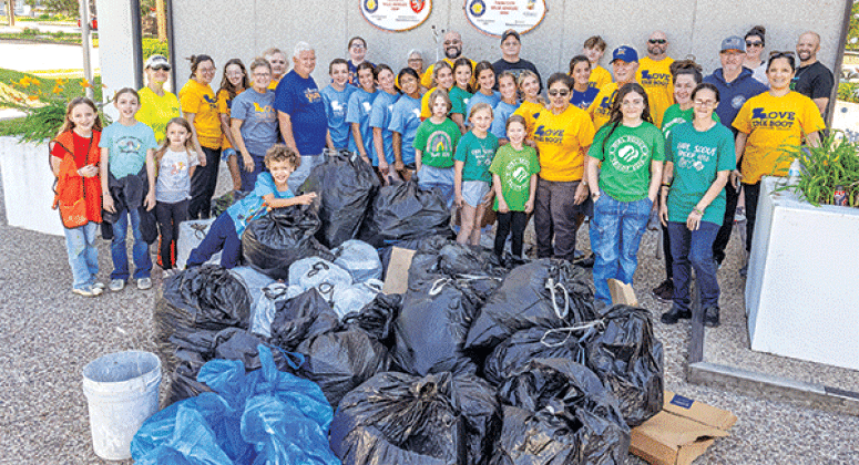 Volunteers assembled for a photo by City Hall after the cleanup on Saturday morning. (More photos on Page 2). (Photo by David Simpson)