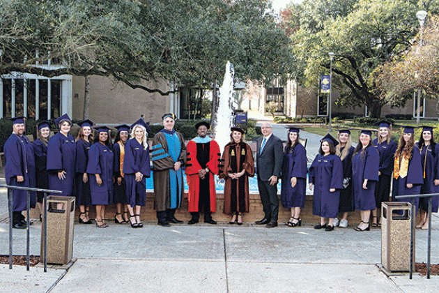 LSUE online graduates, from left, are Robert Couret; Haley Barousse; Olivia Lacombe; Shelby McDonald; Taylor Perrault; Jade Hickman; Brooklynn Ray; Dr. John Hamlin, LSU Eunice vice chancellor for academic affairs and provost; Dr. Nancee Sorenson, LSU Eunice chancellor;  U.S. Eastern District Judge Darrel J. Papillion, Breana Rivette; Breanna Angelle; Chloe Maturin; Sadie Stephens; Kayley Stanfield; Lauren Mullins; and Natalie Bourque.