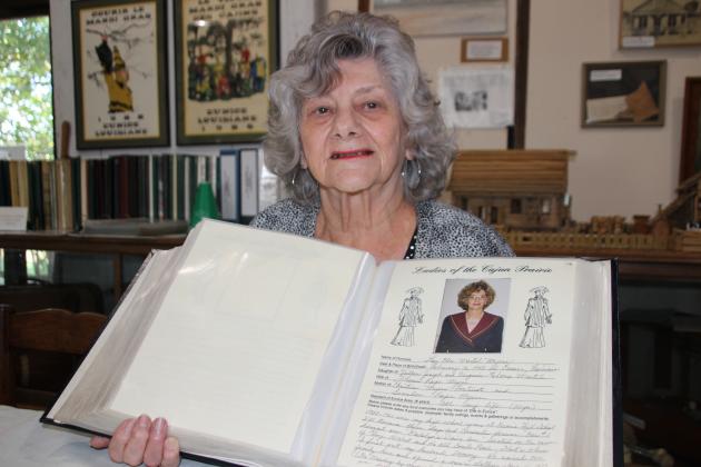 Lou Myers holds up a page that features herself.