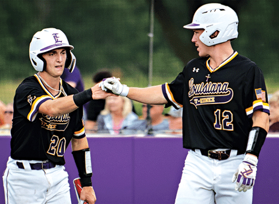 Will Mabry IV, right, congratulates Milan Obradovich after scoring an early run in LSUE’s win over Bossier Parish. (LSUE photo)