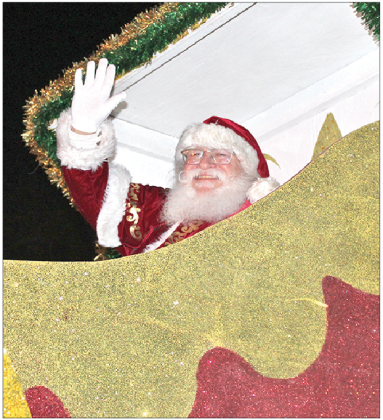 Santa Claus gives a wave from high atop his float in the 2025 Eunice Christmas Parade of Lights, presented by the Eunice Chamber of Commerce, on Thursday, Dec. 11, in downtown Eunice. The event featured many floats as well as several high school marching bands from around the area. (Photo by Myra Miller)