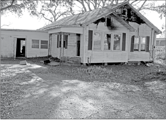 Eunice fire fighters were called to a structure fire at 152 East Ardoin at 4:14 p.m. Friday. According to Eunice Fire Chief Chaise Brown, “The home was unoccupied. It is located next door to Guillory Oil storage tanks.” The cause of the fire is under investigation. (Photo by Myra Miller)