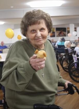 Smiling woman holding new stuffed puppy