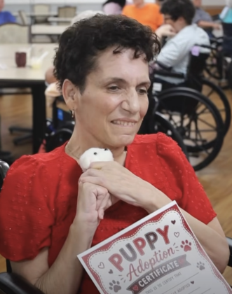 Smiling woman holding stuffed puppy close