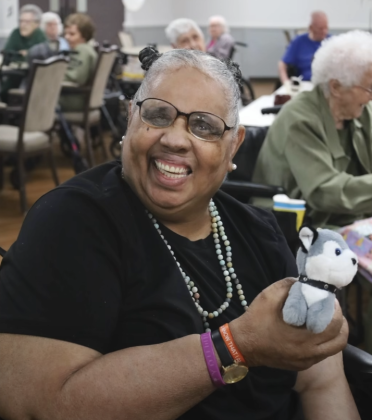 Smiling woman holding new puppy