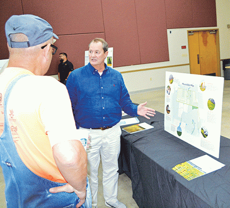 Todd Fontenot of Acadian Land Services points out the location of the farm to parish property owners.
