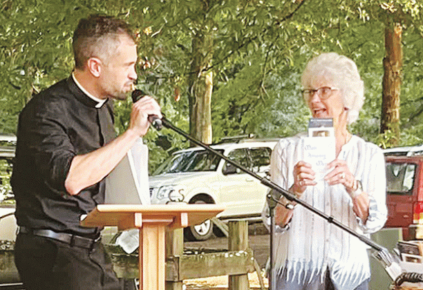 Carrol LaFleur, right, talks about books on the life of the Rev. Verbis LaFleur, who was declared a servant of God by the Diocese of Lafayette. On the left is the Rev. Travis Abadie, pastor of St. Francis Regis Catholic Church of Arnaudville. (Photo courtesy of St. Bernard Catholic Church)