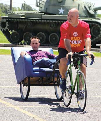 Ralph Zuke, a St. Louis, Missouri, Rotarian pedals Eunice Rotarian Coby Clavier at VFW Post 8971 on Thursday. Zuke was headed to the Rotary International Convention in Houston and raising money to eradicate polio. (Photo by Myra Miller)