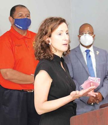 Dr. Tina Stefanski talks about the delta strain of the COVID-19 delta strain that is surging in Louisiana to record levels and filling hospitals during a news conference Monday at the Delta Grand Theatre in Opelousas. Behind her, from left, are Opelousas Mayor Julius Alsandor and St. Landry Parish Superintendent of Schools Patrick Jenkins. (Photo by Harlan Kirgan)