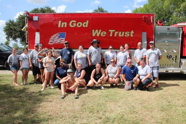Group picture in front of firetruck