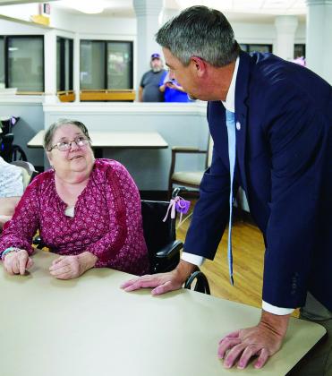 Eunice Mayor Scott Fontenot visits with a senior