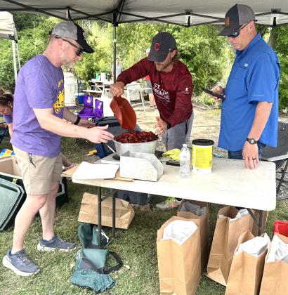 Crawfish for a Cure Organizer David Reed serves a customer with the help of charity volunteers. (Photo by Rebecca Chaisson)