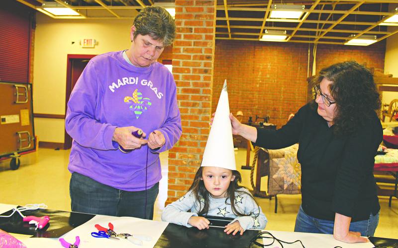 The Mardi Gras events at the Prairie Acadian Cultural Center in Eunice on Saturday included Children’s Capuchon Making. Children had the opportunity to craft their own Mardi Gras capuchon. From left are Laura Launey of Ville Platte, Aleda Launey, 4, of Eunice, and Melissa Walker, of Eunice.