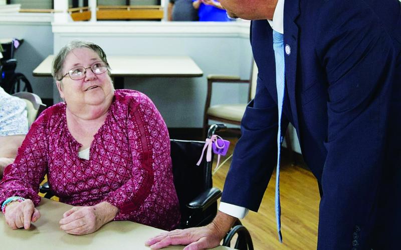 Eunice Mayor Scott Fontenot visits with a senior